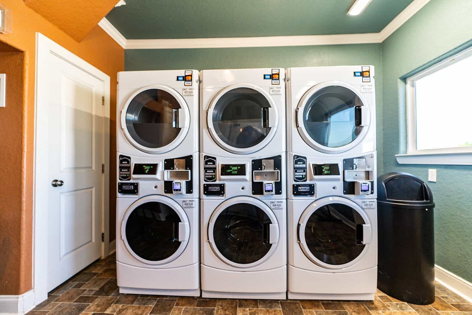 Laundry room with stacked Maytag commercial washers and dryers
